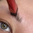 Close-up of angled eyebrow brush for concealer shaping natural eyebrow hairs