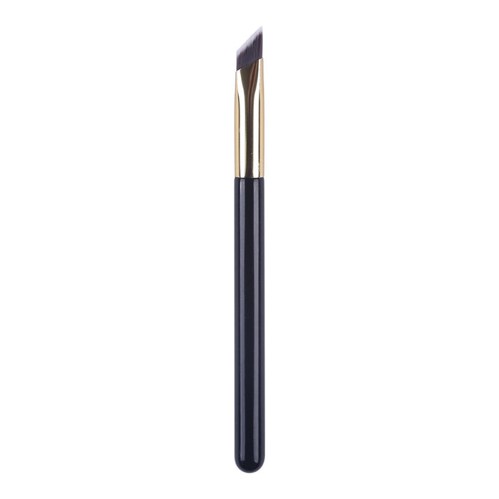 Angled eyebrow brush for concealer with black handle and gold ferrule for precise makeup application