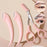 Pink eyebrow trimming knife set with protective covers and small scissors for precise eyebrow grooming