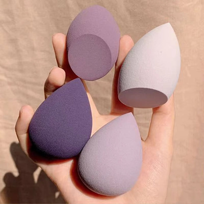 Set of four Cosmo makeup blending sponge in different shades held in hand for flawless makeup application
