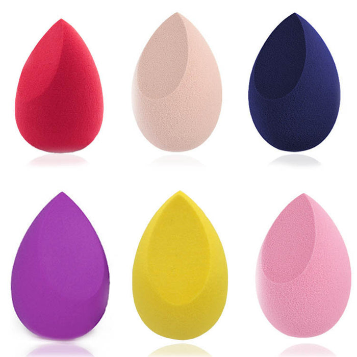 Set of six colorful makeup blending sponges in red, beige, navy, purple, yellow, and pink shades