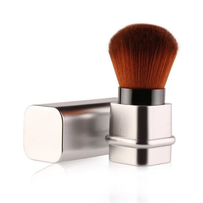 Compact travel makeup brush for foundation with soft brown bristles and silver protective case